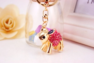 Detail of pink rhinestone donkey keychain with gold plating and lobster clasp on flower decor