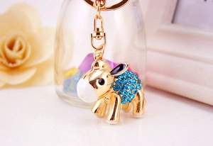 Detailed view of golden donkey keychain with sparkling blue crystals and lobster clasp