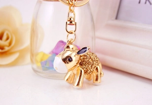 Macro detail of golden donkey keychain with yellow rhinestones and lobster clasp