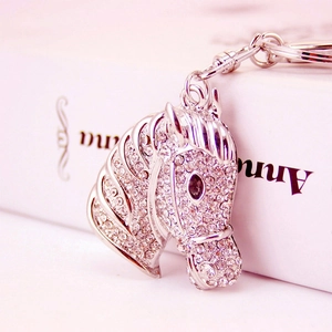 Sparkling rhinestone horse head keychain with silver finish and brown gem eye