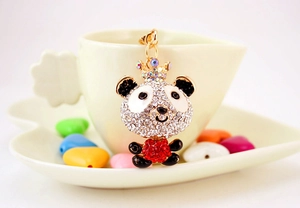 Detail of cute panda bear keychain with sparkling rhinestones and a tiny golden crown charm