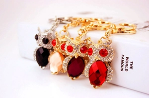 Macro shot of colorful crystal owl keychains with sparkling rhinestones for bags