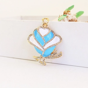 Elegant gold rose keychain with blue enamel petals and sparkling white rhinestones