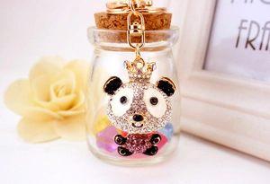 Close-up of a cute panda keychain with shiny rhinestones and a gold lobster clasp