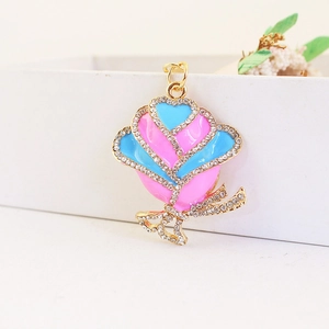 Golden rose flower keychain pendant with pink and blue enamel and sparkling rhinestones
