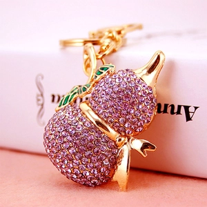 Porte-clés gourde plaqué or avec strass violets et détail de feuille en émail vert