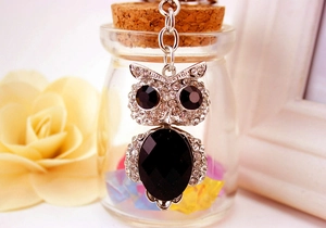 Detailed view of owl keychain with black crystals and sparkling rhinestone accents