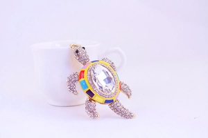 Détail du porte-clés tortue marine en cristal avec alliage doré et émail arc-en-ciel