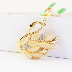 Elegant gold swan keychain with cat eye stones and sparkling crystals for handbags