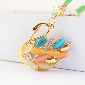 Golden swan keychain with colorful cat eye stones and sparkling rhinestones accessory