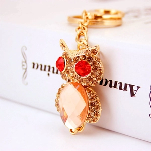 Sparkling crystal owl keychain with golden metal finish and amber rhinestones for handbags