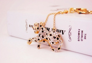 Close-up of a leopard keychain with sparkling white and black crystals on gold plating