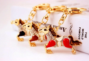 Macro shot of colorful enamel horse keychains with sparkling crystals and gold lobster clasp