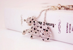 Close-up of leopard keychain with silver finish, crystals, and black enamel spots