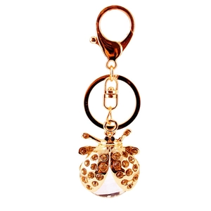 Porte-clés coccinelle orné de strass champagne et cristal sur métal doré brillant