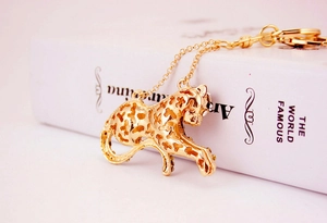 Macro side view of gold-plated hollow leopard keychain with sparkling crystal rhinestones