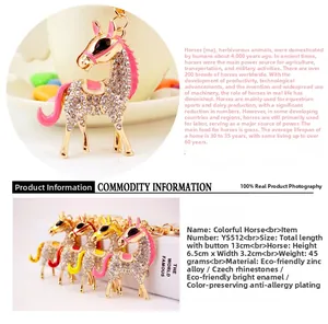 Close-up of a golden horse keychain with sparkling crystals and colorful enamel details