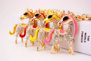 Detailed view of colorful rhinestone-encrusted horse keychains with gold metal finish