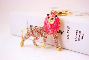 Close-up of golden lion keychain with sparkling pink rhinestones and high detail