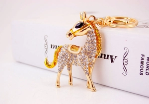 Detail of horse keychain with crystal rhinestones on a gold-plated horse accessory