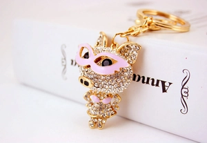 Gros plan d'un porte-clés cochon en strass brillant avec lunettes roses et métal doré
