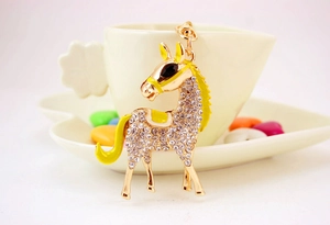 Detailed view of horse keychain with white rhinestones and yellow enamel accents