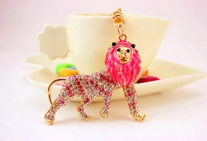 Detailed close-up of a pink lion charm with sparkling crystals and enamel mane finish