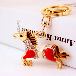 Sparkling crystal horse keychain with red enamel accents and gold alloy finish