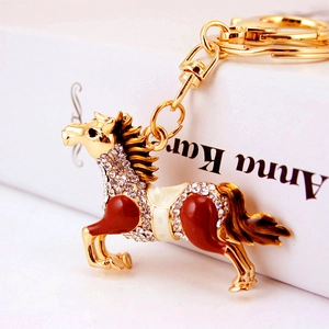 Luxurious gold alloy horse keychain with sparkling crystals and red enamel finish