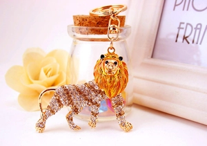 Close-up of golden lion keychain featuring sparkling rhinestones and lobster clasp detail