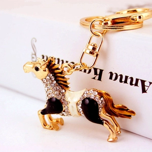 Sparkling crystal horse keychain with golden finish and white rhinestones for bag charm