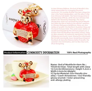 Detailed close-up of Caishen key ring with red enamel and white rhinestone inlays