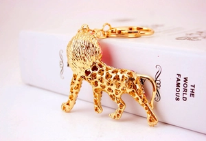 Detailed shot of golden lion keychain with pink zircons and hollow leopard pattern