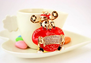 Close-up of God of Wealth keychain with red enamel and sparkling rhinestones