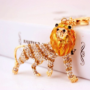 Golden lion keychain with crystal rhinestones on white box background for bags