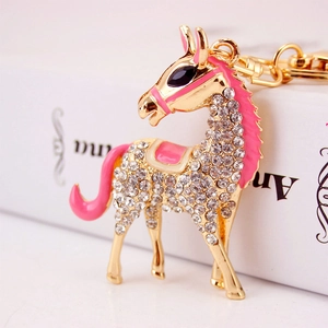 Cute horse keychain with sparkling crystals and pink enamel details in golden finish