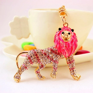 Sparkling lion keychain with pink enamel and crystals on a golden metal base