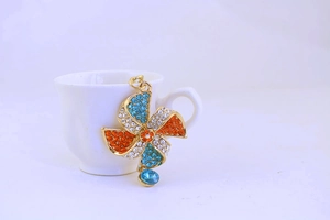 Detail of crystal windmill keychain with colorful rhinestones and blue drop pendant