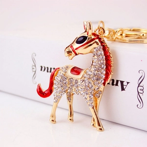 Sparkling crystal rhinestone horse keychain with gold metal and red enamel accents