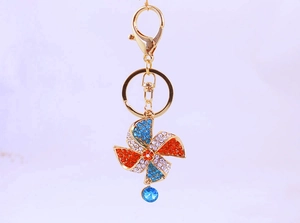 Detail view of the colorful crystal windmill keychain with golden lobster clasp and ring