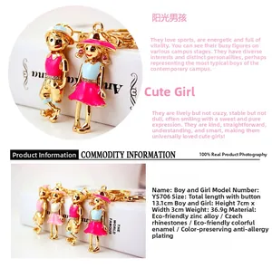 Close-up of cute cartoon boy and girl keychains with pink and blue enamel and Czech rhinestones