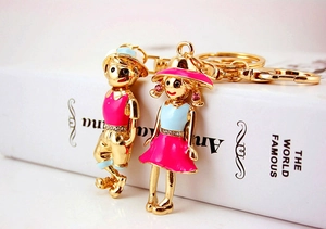 Detail of cute couple keychains with enamel finish and sparkling crystal accents
