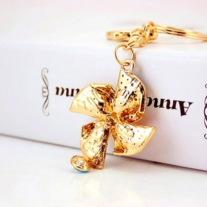 Cute crystal windmill keychain in golden alloy finish with textured surface for women