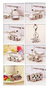 Detailed close-up views of a crystal-encrusted train locomotive keychain with lobster clasp