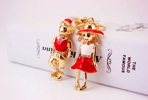 Detail of couple figurines keychains with red enamel and sparkling crystal accents