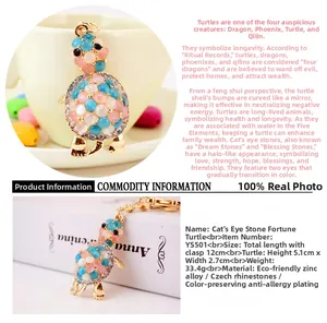 Detailed close-up of a rhinestone turtle keychain with pink and blue opal inlays