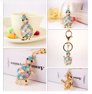 Detailed views of a gold turtle keychain with pink opal stones and sparkling rhinestones