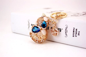 Macro view of golden gourd keychain with blue rhinestones and Fu character charm