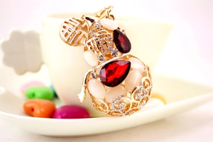 Detailed view of golden gourd keychain with red water-drop gems and lucky Fu charm