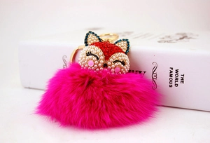 Detail of rose pink faux fur fox keychain with sparkling rhinestones and pearl accents